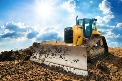 Excavator with blue sunny sky in the background